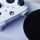 An Xbox Series S sits on top of a table.